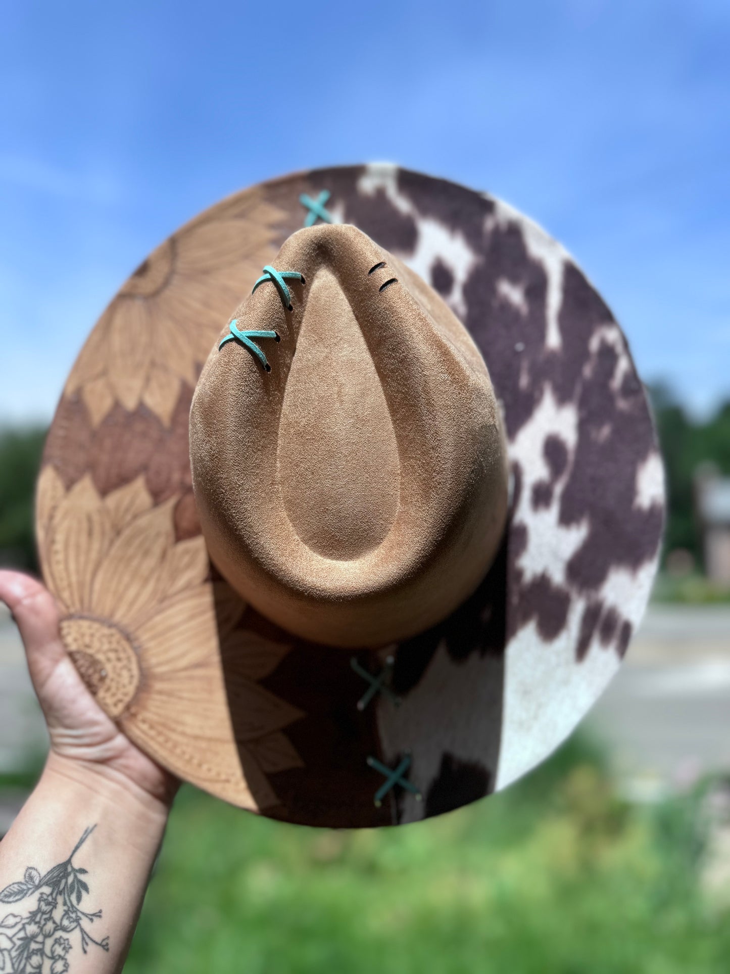 Reverse burned sunflower /cowprint hat with a touch of teal