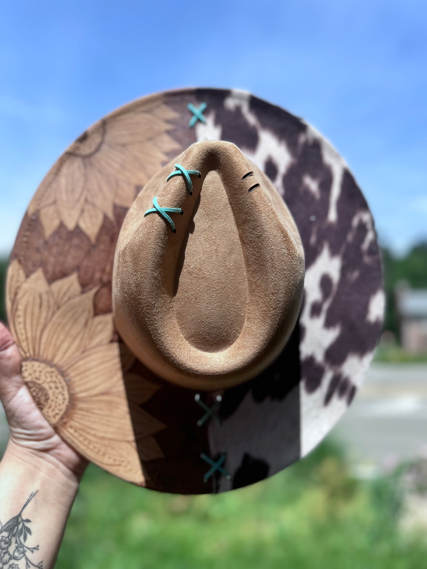 Reverse burned sunflower /cowprint hat with a touch of teal