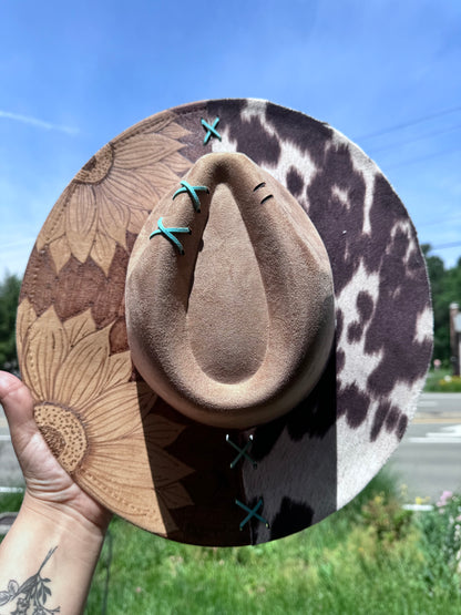 Reverse burned sunflower /cowprint hat with a touch of teal